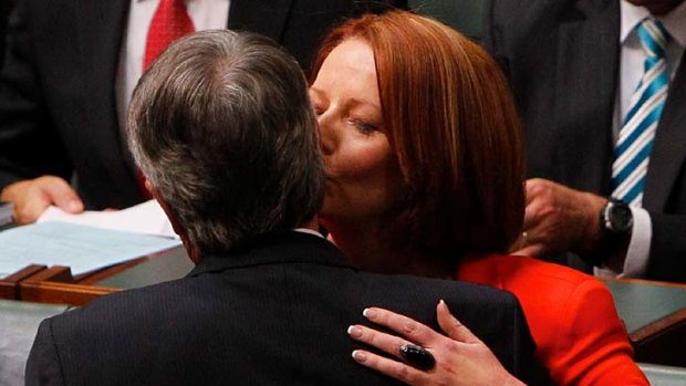 Prime Minister Julia Gillard embraces Treasurer Wayne Swan after he delivered the Budget Address in Parliament House.