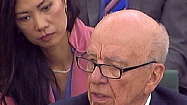 Out of touch ...  Rupert Murdoch answers a question as his wife Wendi Deng looks on.