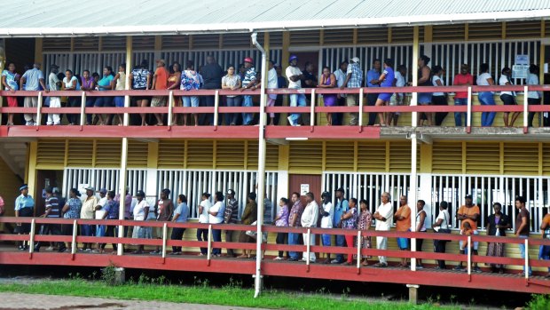 Voters line up to cast their votes in Guyana, where a new multi-racial party has now taken power. 