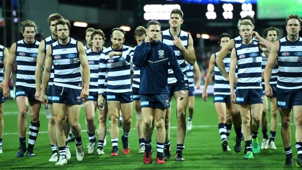 Joel Selwood of the Cats (centre) leads the Cats off Skilled Stadium after loss to the Swans.