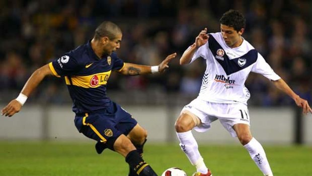 Boca's Jesus Mendez (left) takes on Victory's Marvin Angula.