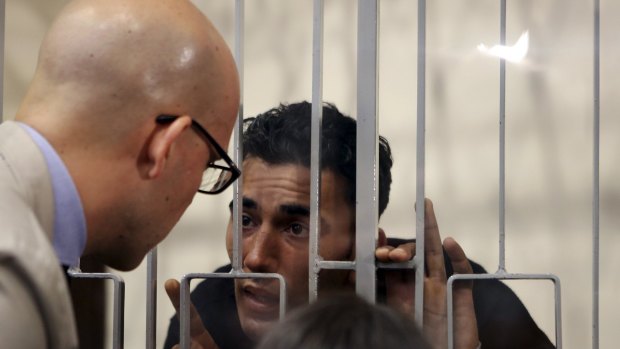 Mohammed Ali Malek (right) speaks with his lawyer, Massimo Ferrante, at Catania's tribunal. 