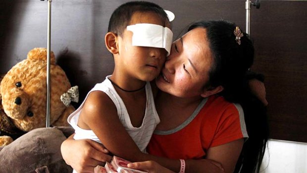 Guo Bin, known as Bin-Bin, with his mother in a hospital in Taiyuan, north China's Shanxi province.