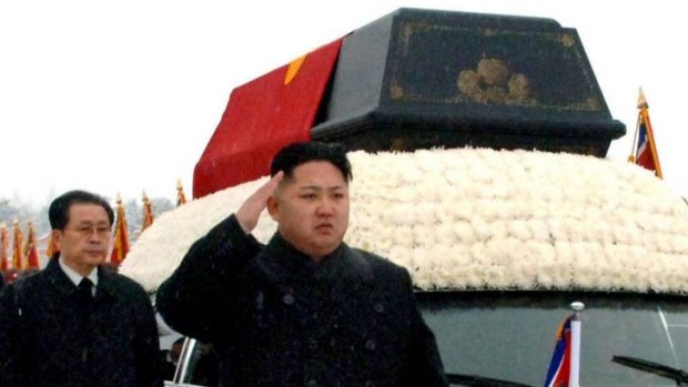 Family ties: Kim Jong-un salutes beside the hearse carrying the body of his father in December 2011, with uncle Jang Song-thaek a few steps behind.