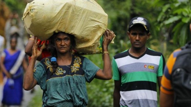 Forced to retreat: A Sri Lankan woman carries her belongings.