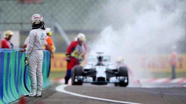 Lewis Hamilton watches his pole position go up in smoke.