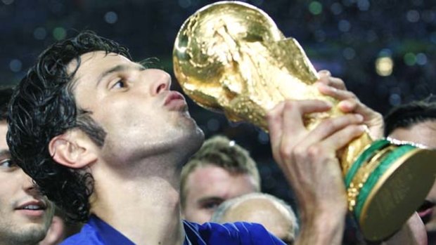 Fabio Grosso kisses the World Cup after scoring the winning penalty in the 2006 final.
