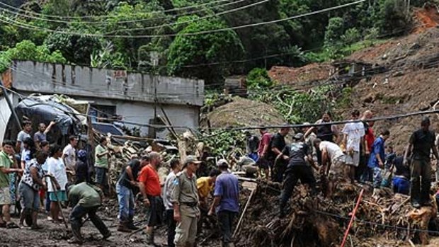 Rescue workers search for victims after heavy rains caused mudslides in a low-income neughbourhood in Teresopolis, some 100 km from downtown Rio de Janeiro.