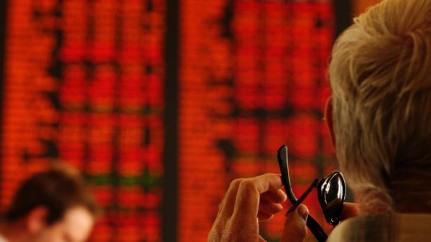Highs and lows: Traders watch the ASX stock board.