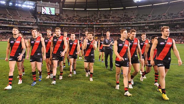 It's over at last: Essendon players leave the ground after being defeated by Richmond.