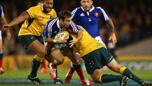 France's Morgan Parra is tackled by the Wallabies' defence during Australia's 6-0 win at Melbourne last Saturday night.