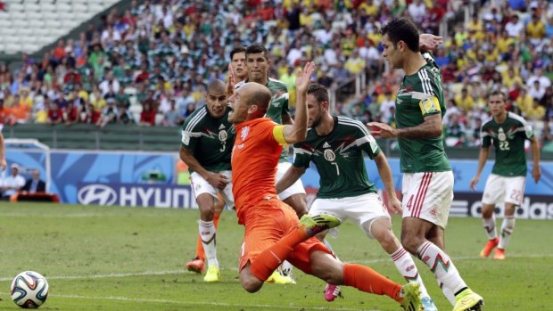 Talented and dramatic ... Netherlands' Arjen Robben, centre, goes down to win a penalty against Mexico.