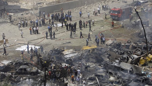 Iraqis inspect the damage near the Iraqi Foreign Ministry after a massive bomb attack in Baghdad, Iraq.