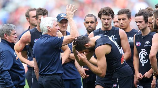 Mick Malthouse addresses his players at three-quarter time, when they trailed Melbourne by 21 points.