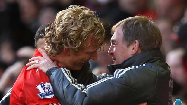 Manager Kenny Dalglish embraces Dirk Kuyt at the end of Liverpool's match against Manchester United.