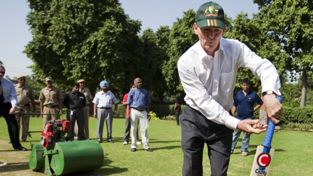 John Brumby shows his prowess at an impromptu bat and bowl on the lawns of St. Stephens College at Delhi University.