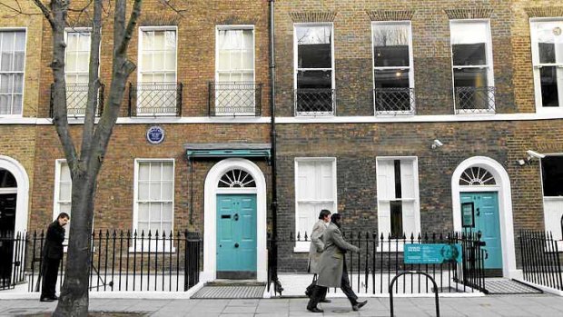 People walk past Charles Dickens' home, left, part of the Charles Dickens Museum in London.