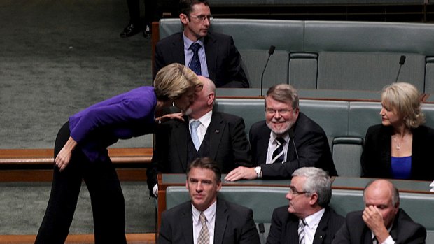Deputy Opposition Leader Julie Bishop gives Liberal MP Mal Washer a kiss after he crossed the floor to vote with the government. He eventually voted with the opposition.