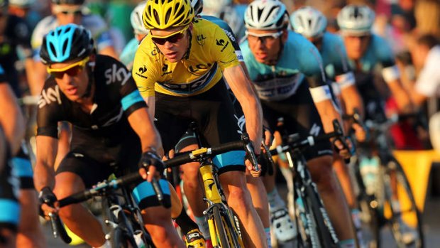 Chris Froome rides on the wheel of teammate Richie Porte in the final stage of the Tour de France.
