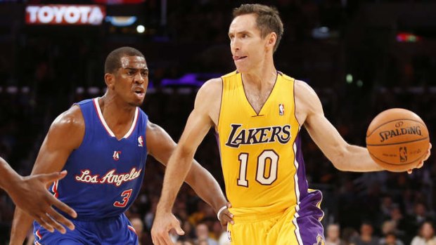 Los Angeles Lakers veteran Steve Nash tries to avoid Clippers counterpart Chris Paul in their NBA season-opening match.