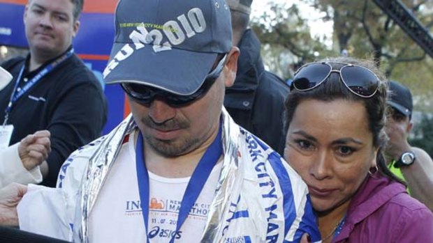 Angelica Alvarez embraces her husband, Chilean miner Edison Pena, after he crossed the finish line in the New York City Marathon  on Sunday.