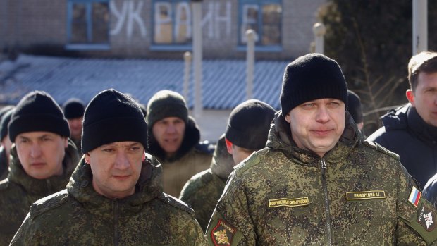 Russian servicemen, members of trilateral groups of observers, walk along a street in Soledar, Donetsk region.