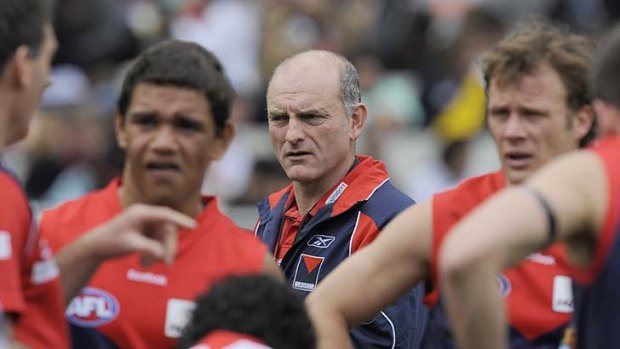 Melbourne coach Dean Bailey with his team at quarter time during the round 18 clash against Richmond in 2009. Melbourne lost the game by four points.