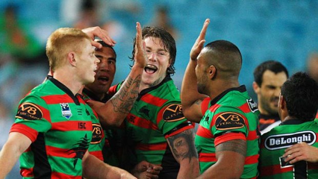 Rabbitohs celebrate a Fetuli Talanoa try in their 29-18 victory.