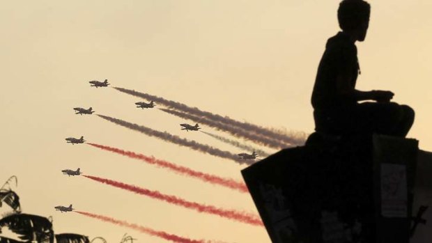 Egyptian military jets fly in formation over Tahrir square in Cairo.