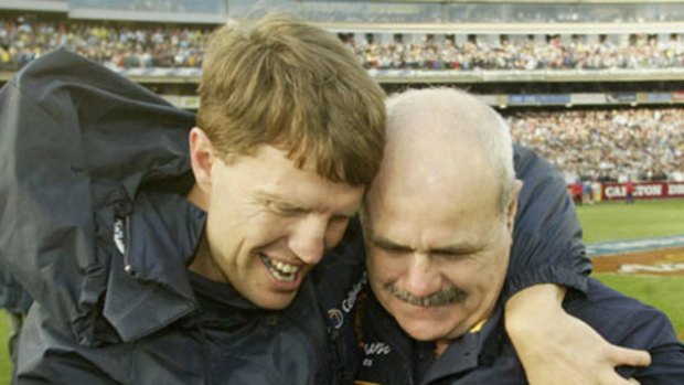 Graeme Allan hugging Lions coach Leigh Matthews after the 2002 grand final.