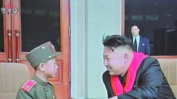 This image from North Korean TV shows North Korean leader Kim Jong-Un chatting with a child dressed in military uniform during a ceremony to mark the 66th anniversary of the Korean Children's Union