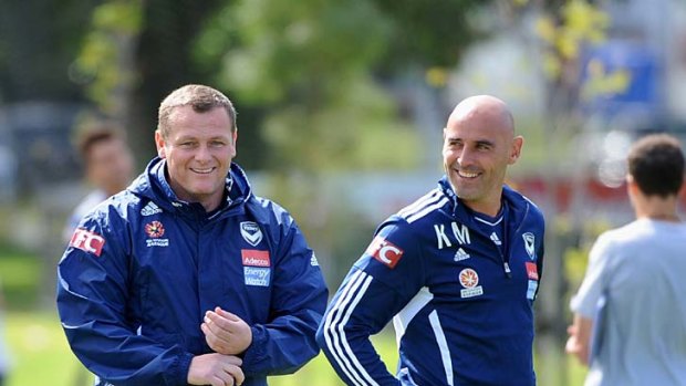 Having a laugh: Jim Magilton and assistant Kevin Muscat direct Victory's preparation for Friday's match against Adelaide.