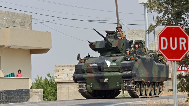 Turkish troops heading towards the Syrian border. 