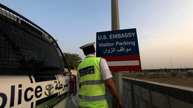 Set to re-open: A police officer on the road leading to the US Embassy in Bahrain, one of the many diplomatic posts closed following an unspecified terrorist threat.