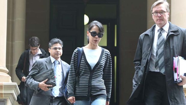 Kathy Lin, wife of  Robert Xie leaves Central Local Court with Mr Xie's barrister, Graham Turnbull, SC, at an earlier hearing.