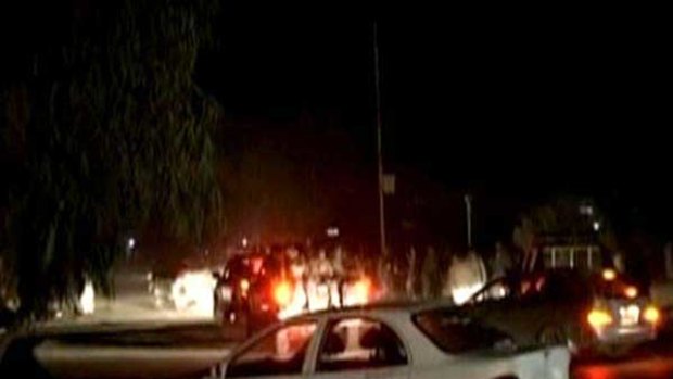 A screen grab shows a police convoy at the site of a bomb blast in Kandahar.