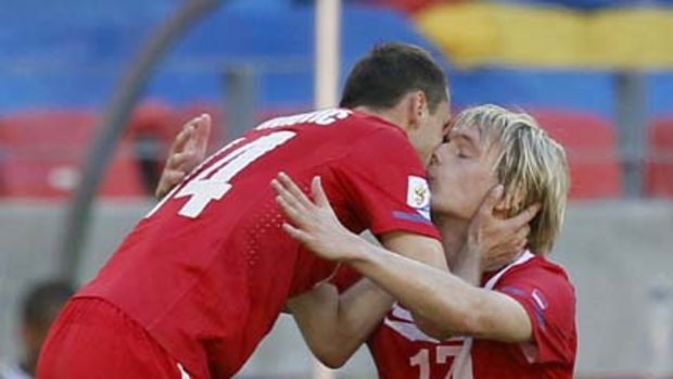 Serbia's Milan Jovanovic (14) celebrates with teammate Milos Krasic after scoring what turned out to be the match-winner.