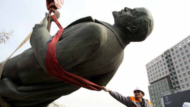 Out with the new .. a statue of Lenin is removed from its plinth in Ulan Bator last year as the country moves to celebrate a more ancient history.