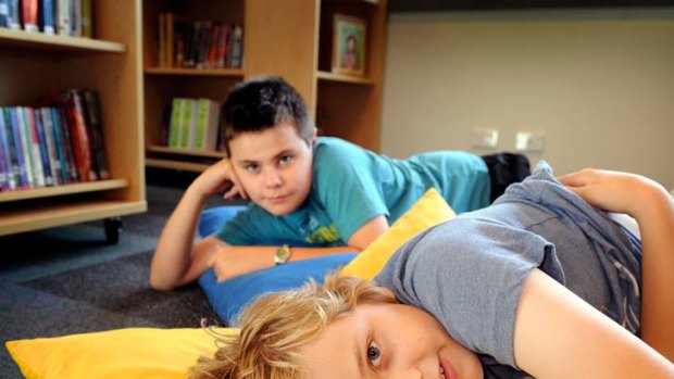 Two of Clifton Hill Primary School's autistic students, Mitchell Swannie (back) and Adam Dickson in the school library.