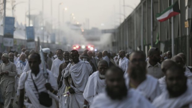 Pilgrims walk by the site where hundreds were crushed and trampled to death during the annual hajj pilgrimage in Mina, Saudi Arabia.