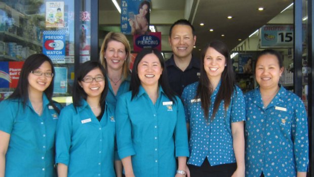 Adapting ... pharmacy co-owners Lillian Chen (front centre) and husband Jonathan with staff.