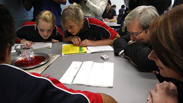 Back to basics ... Kevin Rudd and Julia Gillard observe a science experiment at Amaroo School in Canberra on Monday.