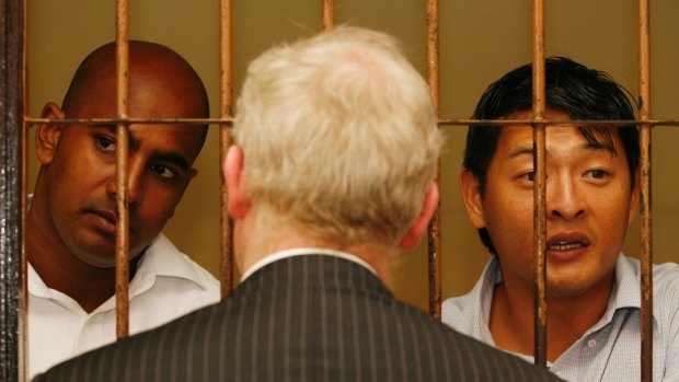 Andrew Chan (right) and Myuran Sukumaran talk with their Australian barrister, Julian McMahon, in 2010.