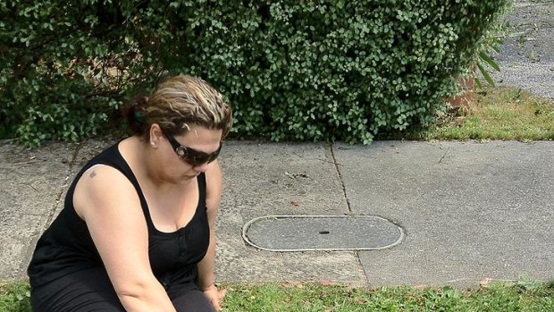 A woman lays flowers at the scene of a deadly crash in Ringwood.