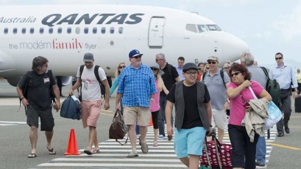 <i>Modern Family</i> cast members Rico Rodriguez (front, 2nd R) and Eric Stonestreet (C, in checkered blue) arrive at Queensland's Great Barrier Reef Airport on Hamilton Island.