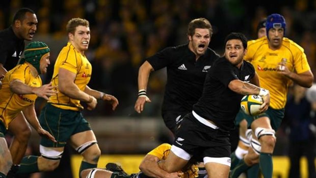 Merely hanging on . . . Australian defence clings on to All Blacks Piri Weepu as the New Zealanders go on the charge during last night's comprehensive defeat of the Wallabies in Melbourne.