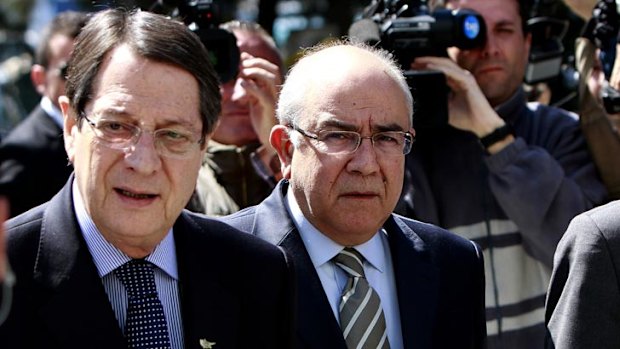 Crucial parliamentary vote ahead ... Cypriot President Nicos Anastasiades, left, and President of the Parliament Yiannakis Omirou walk toward the Parliament following a meeting in capital Nicosia, Cyprus.