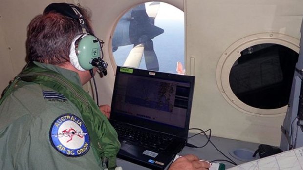 A crew member of a RAAF AP-3C Orion keeps his eyes peeled for a sign of the Malaysia Airlines plane.