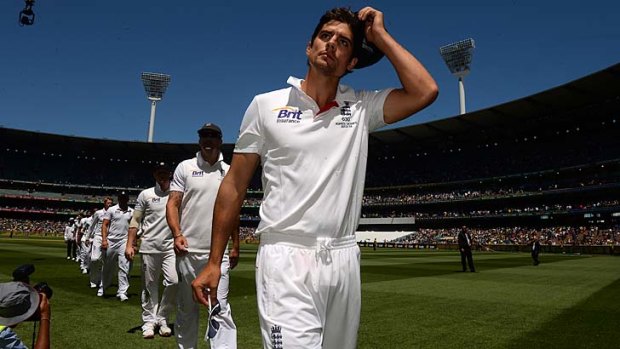 Alastair Cook leads his team off the field after its loss.