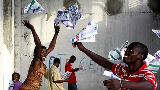 Haitians throw ballot papers in the air after frustrated voters destroyed electoral material during a protest at a voting centre in Port-au-Prince.